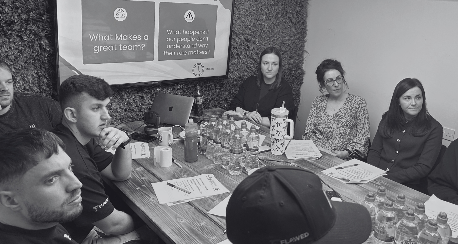 group of people around table team work saturn four media